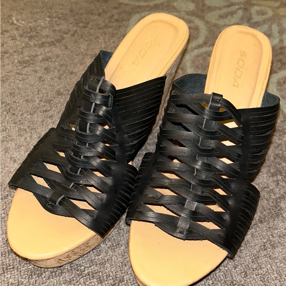 Tan cork wedge slides with synthetic black uppers.